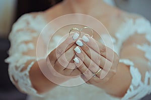 Bride holding wedding rings