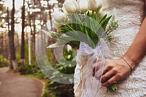Bride holding white elegant modern autumn wedding bouquet.