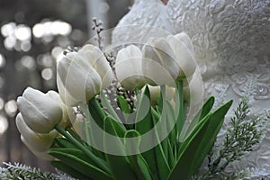 Bride holding white elegant modern autumn wedding bouquet.