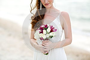 Bride holding white rose flower wedding bouquet
