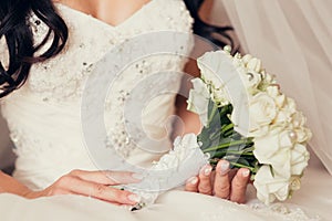 Bride holding white roses bouquet