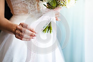 The bride holds a beautiful wedding bouquet