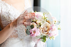 The bride holds a beautiful wedding bouquet