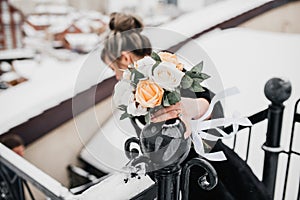 The bride holds her beautiful wedding bouquet with gentle hands