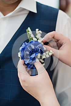 The bride holds her beautiful wedding bouquet with gentle hands