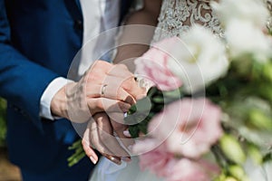 The bride holds her beautiful wedding bouquet with gentle hands