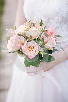 The bride holds a tender bouquet photo