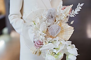 Bride holds wedding boho bouquet