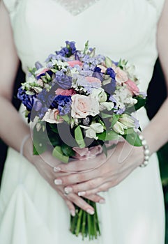 The bride holds a wedding bouquet photo
