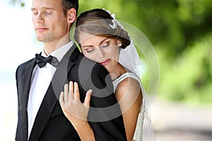 Bride hugging her groom from behind