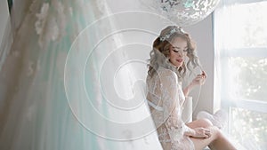 Bride in lace negligee near the window