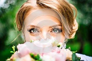 Bride with large green eyes looks into the camera