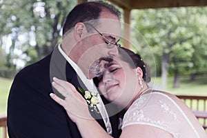 Bride Lays Head on Grooms Shoulder