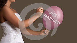 Bride lets a Balloon with Text burst with a needle