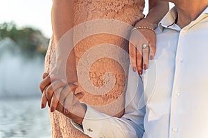 Bride lien on the grooms shoulder. Standing side by side