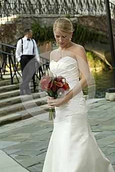 Bride Looking at Flowers with Groom