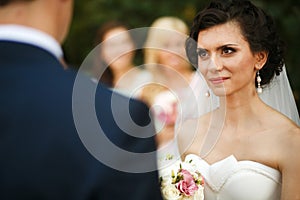The bride looking on groom