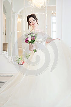 Bride in luxury interior in palace. Wedding, attractive brunette