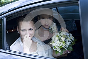 Bride with maid of honour in the car photo