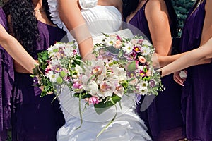 Bride and maids of honor with bouquetes photo