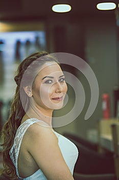 A bride is making a pose in a hairdresser. photo
