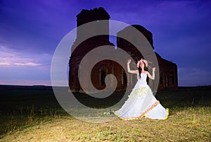 Bride near an old ruined church