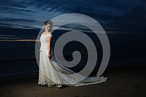 Bride at night by shore