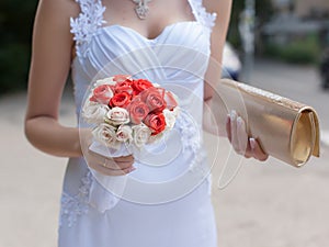 Bride with bouquet and reticule walking on street photo