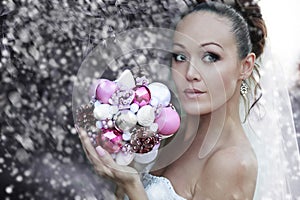 Bride portrait in white bridal veiling with artificial bunch photo session, leaves and trees background, summer weather, fashion