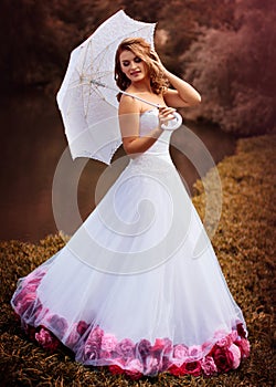 Bride portrait in white bridal veiling with artificial bunch photo session, leaves and trees background, summer weather, fashion