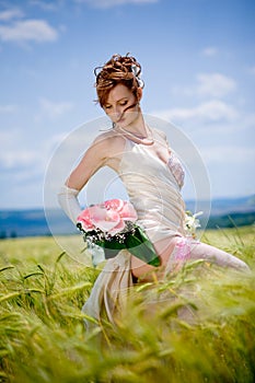 Bride posing in field
