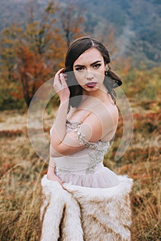 Bride posing in high mountain scenery