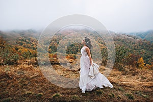 Bride posing in high mountain scenery