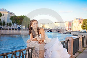 Bride posing outdoor near the river