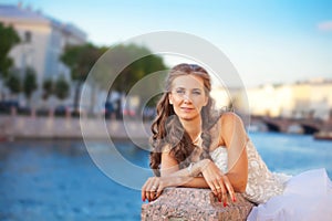 Bride posing outdoor near the river