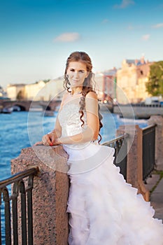 Bride posing outdoor near the river