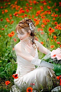 Bride posing among poppies