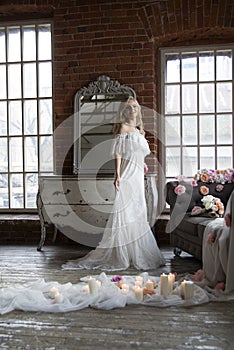 Bride posing reflecting in vintage mirror