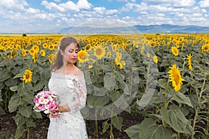 Bride posing in a sunflower field