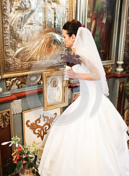 Bride praying in church