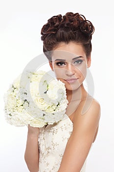 Bride with prom hairdo and fancy bouckuet