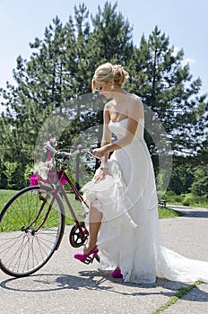 Bride in purple shoes on the bike