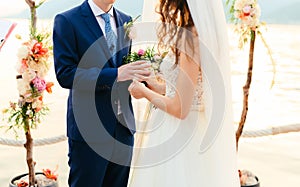 The bride puts the ring on the bridegroom at the wedding ceremon