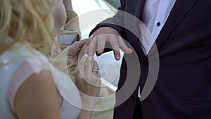 Bride puts on wedding ring to groom`s hand