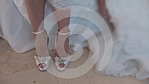 Bride puts on wedding shoes
