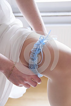 Bride is putting on garter