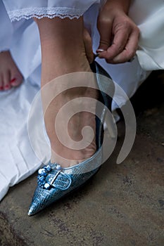 Bride putting on her glamorous shoes