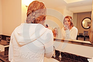 Bride putting on makeup