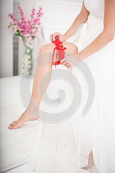 Bride Putting On Red Grater