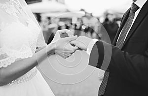 Bride putting ring on groom`s finger
